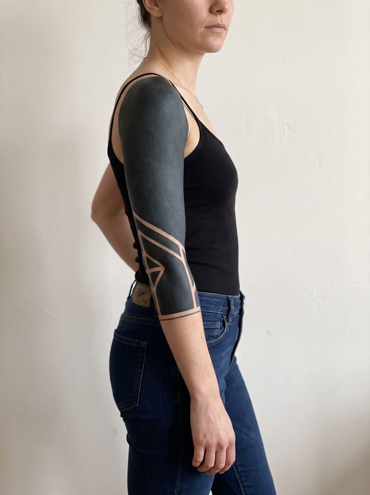 Blackout 3/4 sleeve tattoo — three-quarter sleeve covering shoulder to mid-forearm