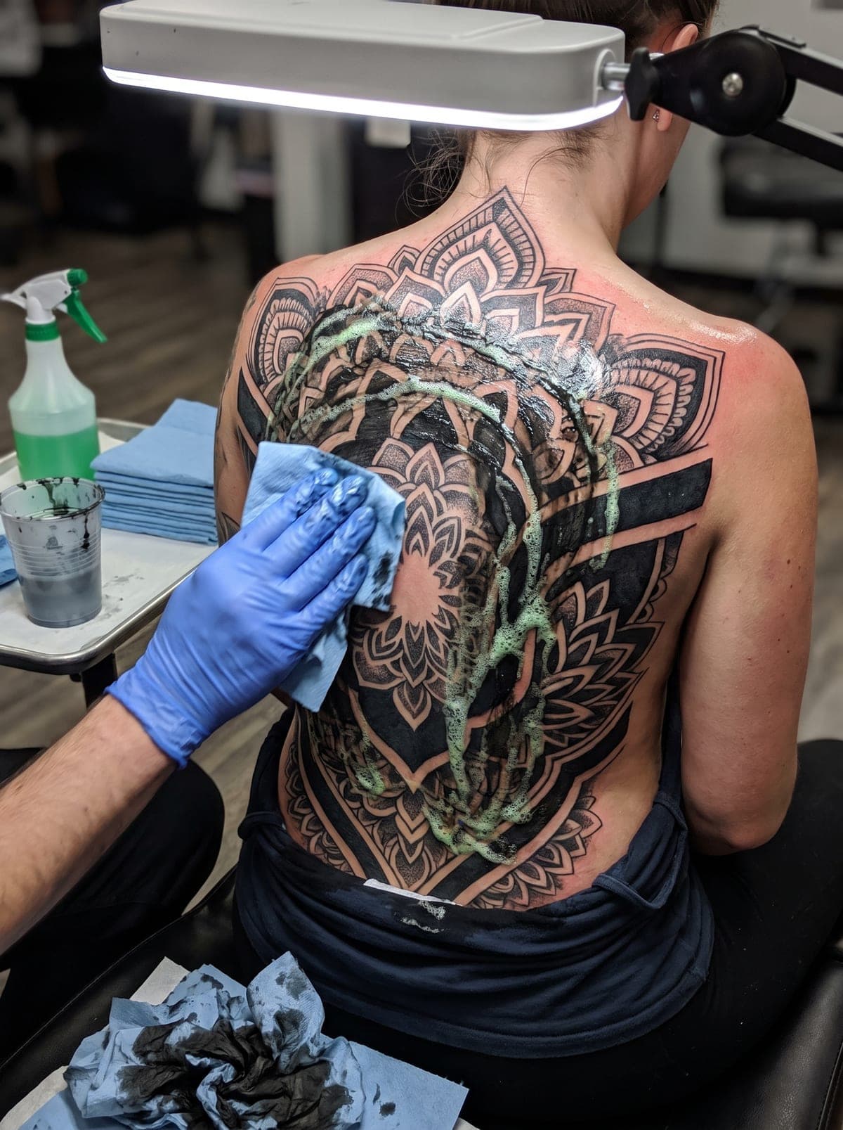 Blackwork back tattoo — full back piece spanning shoulder blades to lower back